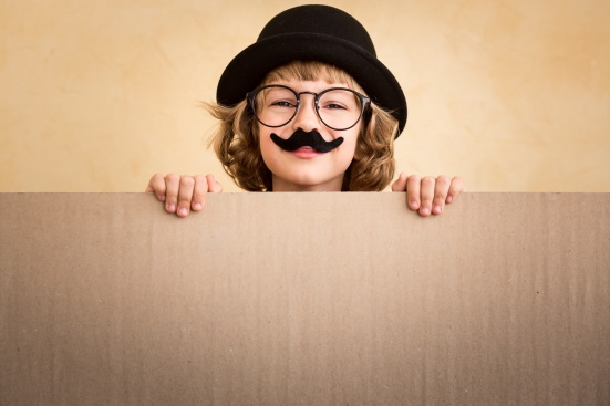 Funny kid with fake mustache holding banner blank